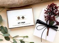 root chakra earrings in a box