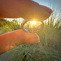 Sun setting showcasing the hidden message printed on the inside PEACE 