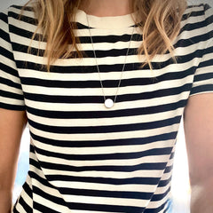 let it be necklace length picture on striped black and white shirt. Necklace hangs mid chest. 24